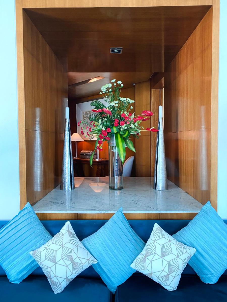 a vase of flowers sitting on top of a table at InterContinental Marine Drive Mumbai by IHG in Mumbai