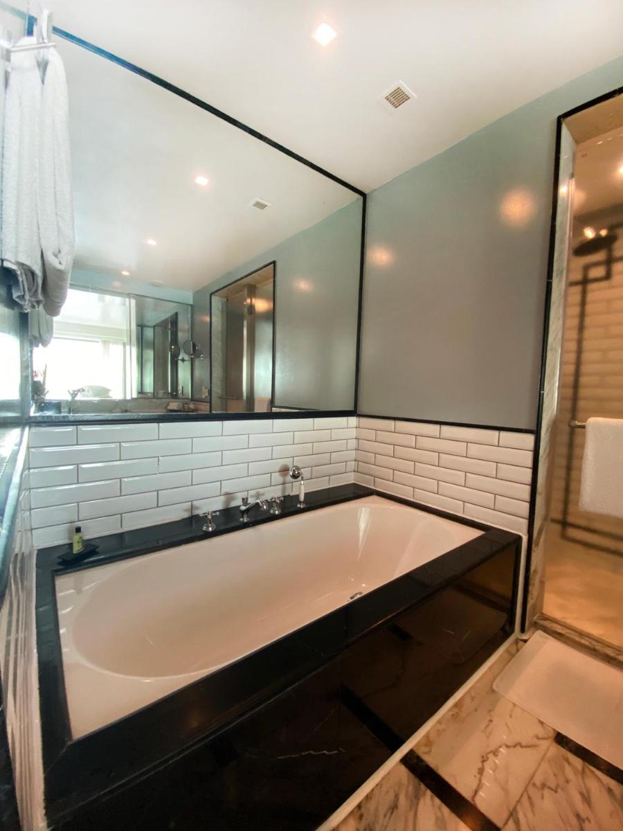 a large bath tub in a bathroom with a mirror at InterContinental Marine Drive Mumbai by IHG in Mumbai