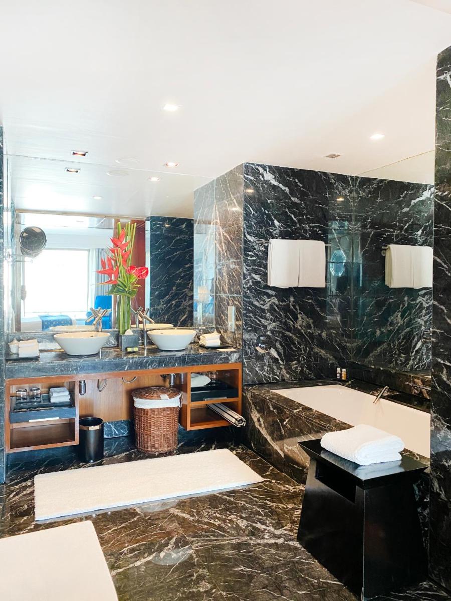 a bathroom with two sinks and a large mirror at InterContinental Marine Drive Mumbai by IHG in Mumbai +215 photos