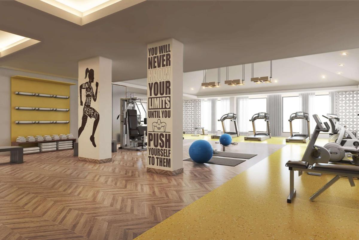 a gym with treadmills and exercise equipment in a room at Hawthorn Suites by Wyndham Dwarka in Dwarka a gym with treadmills and exercise equipment in a room at Hawthorn Suites by Wyndham Dwarka in Dwarka