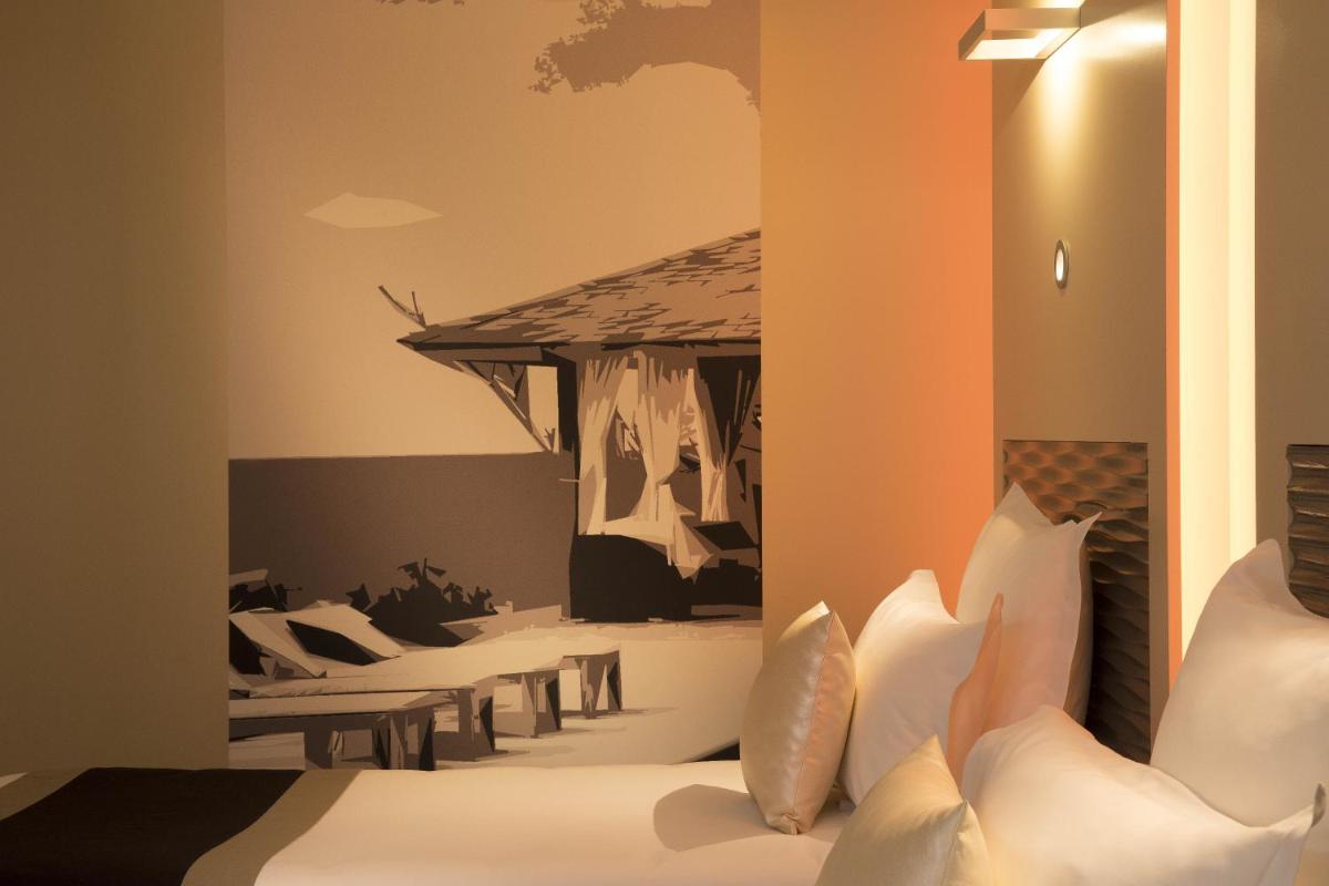 Un ou plusieurs lits dans un hébergement de l'établissement Hôtel Brésil Opéra SPA