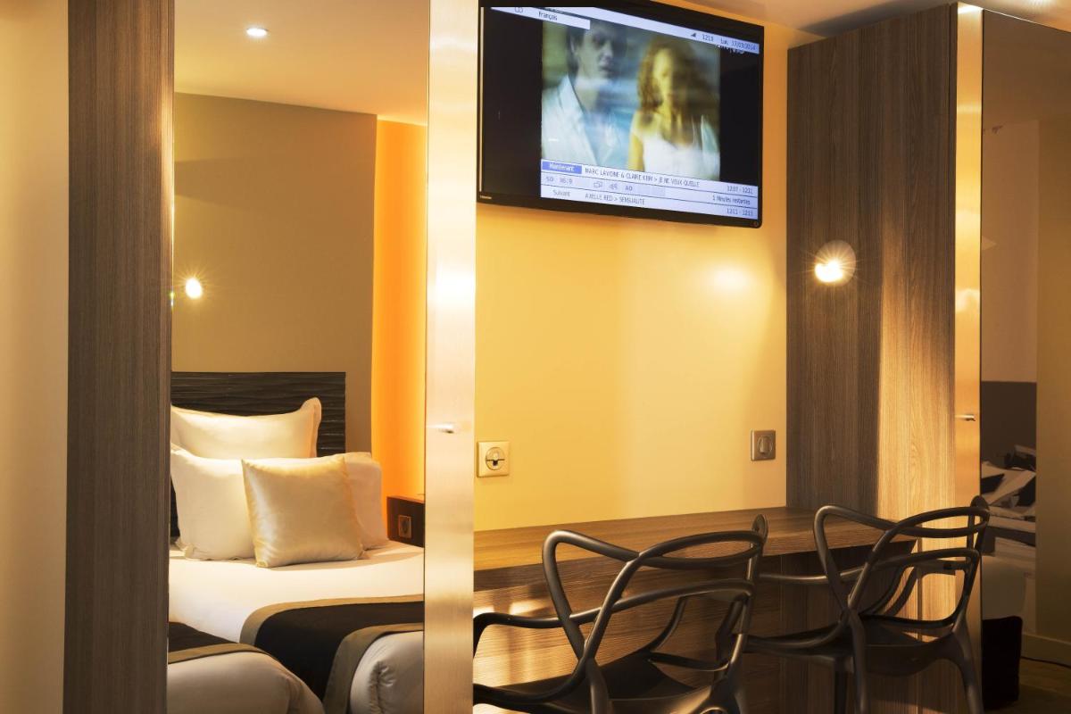Télévision ou salle de divertissement dans l'établissement Hôtel Brésil Opéra SPA