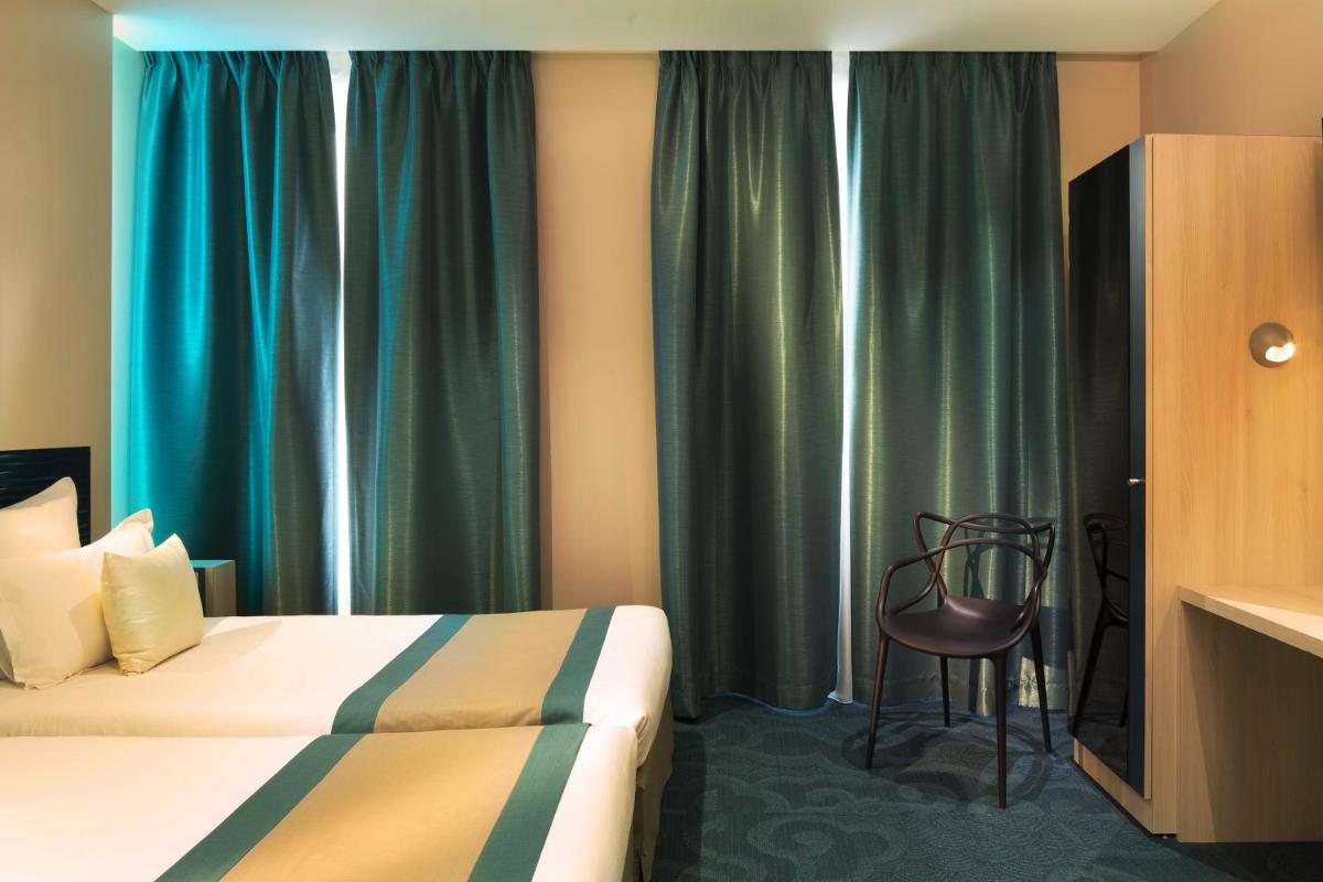 Un ou plusieurs lits dans un hébergement de l'établissement Hôtel Brésil Opéra SPA