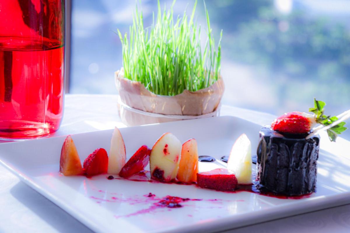 a plate of food with fruit on a table at Holiday Inn Chennai OMR IT Expressway by IHG in Chennai