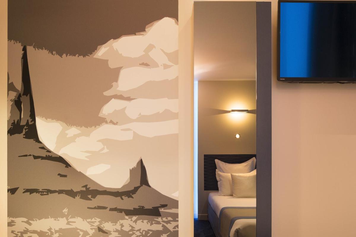 Télévision ou salle de divertissement dans l'établissement Hôtel Brésil Opéra SPA