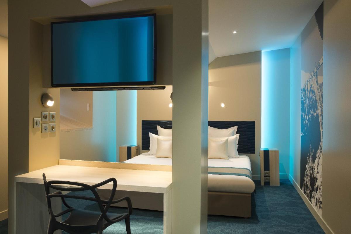 Un ou plusieurs lits dans un hébergement de l'établissement Hôtel Brésil Opéra SPA