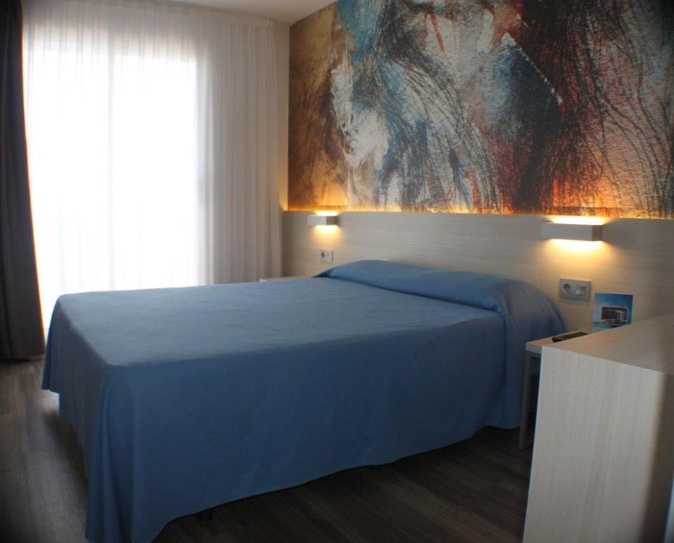 Cama o camas de una habitación en Hotel Riviera