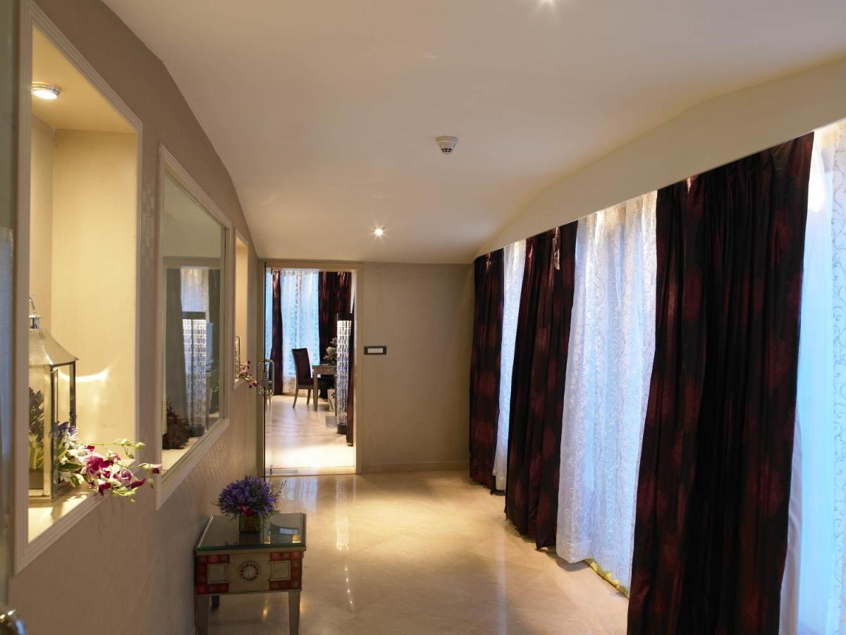 a hallway with curtains on the walls of a house at The Zuri Whitefield Bengaluru in Bengaluru
