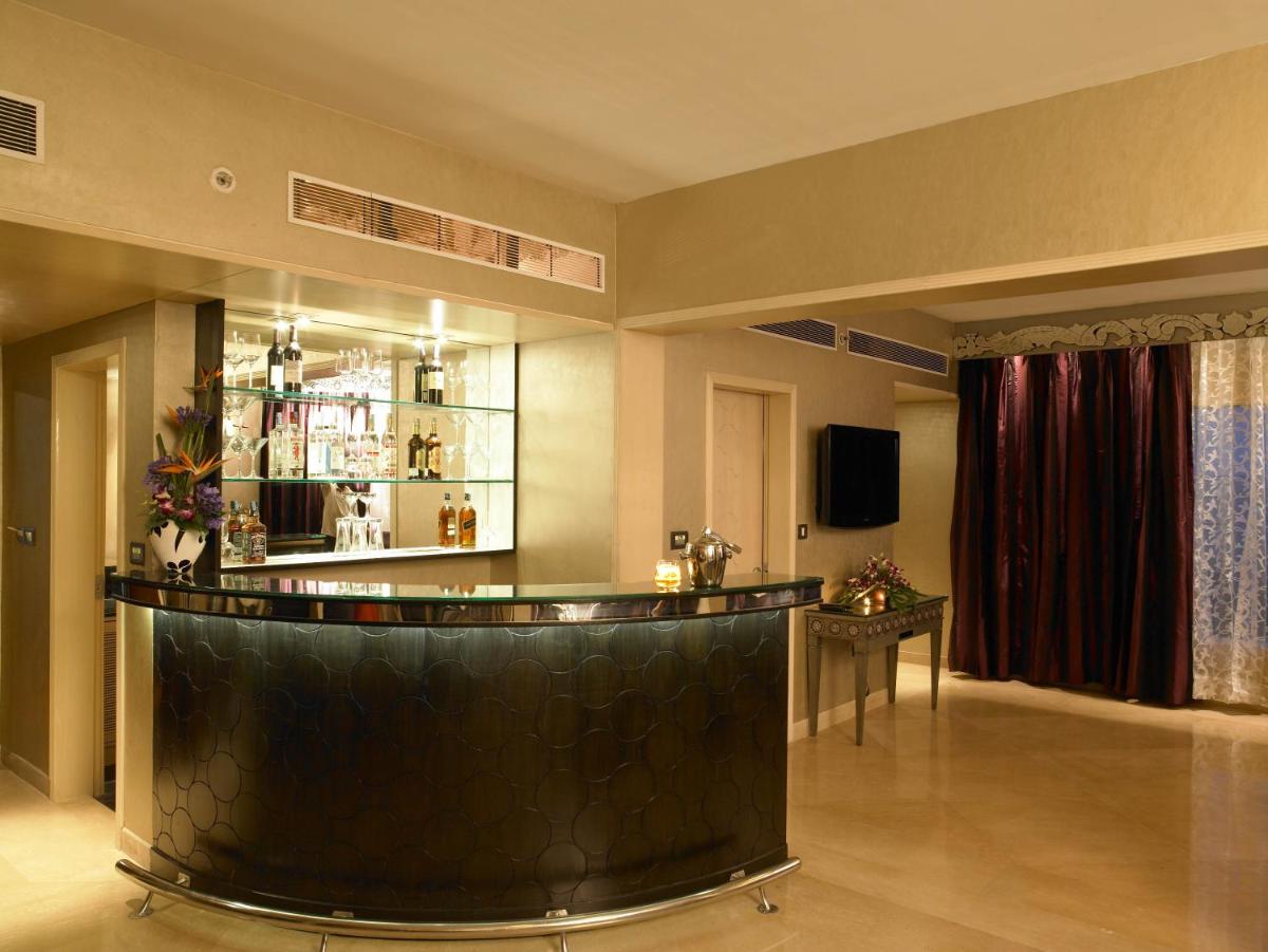 a bar in the middle of a room at The Zuri Whitefield Bengaluru in Bengaluru