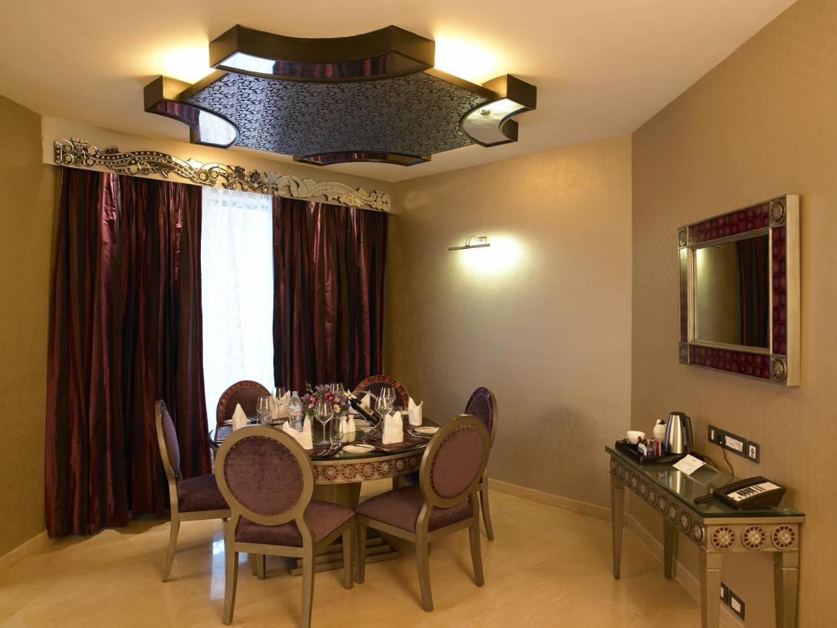 a dining room with a table and chairs at The Zuri Whitefield Bengaluru in Bengaluru