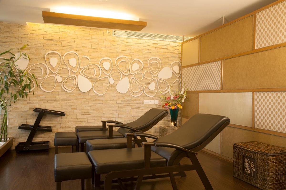 a salon with a row of chairs and a brick wall at Radisson Blu Hotel Pune Kharadi in Pune