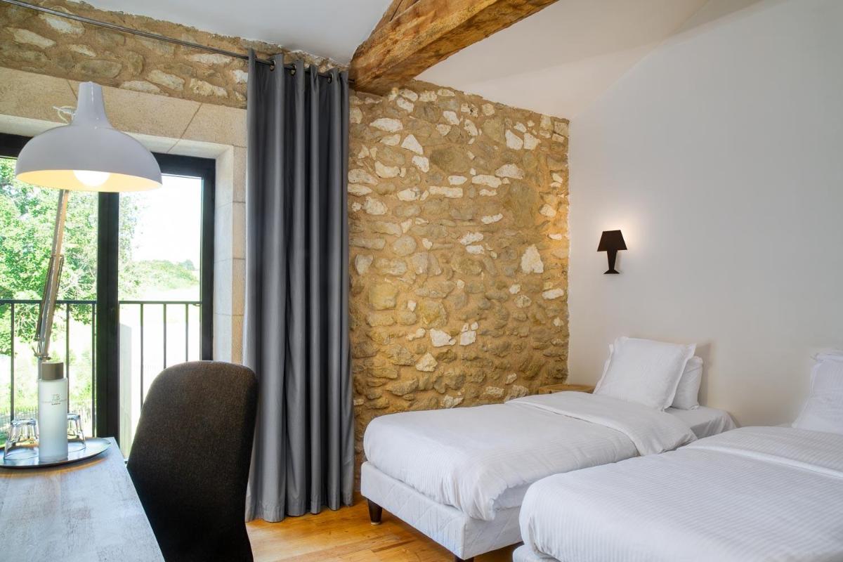 Un ou plusieurs lits dans un hébergement de l'établissement Le Domaine de Baulieu, Singuliers Hotels