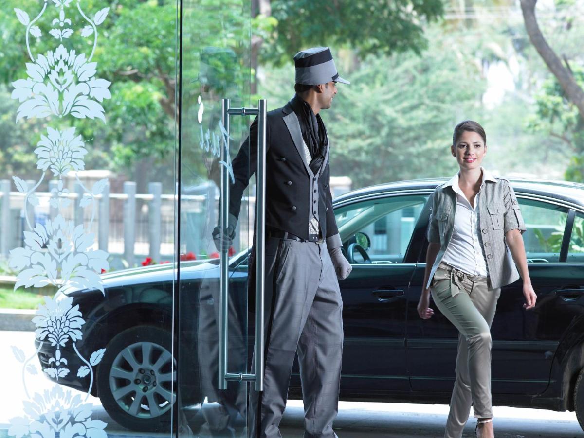 a man and a woman standing next to a car at The Zuri Whitefield Bengaluru in Bengaluru