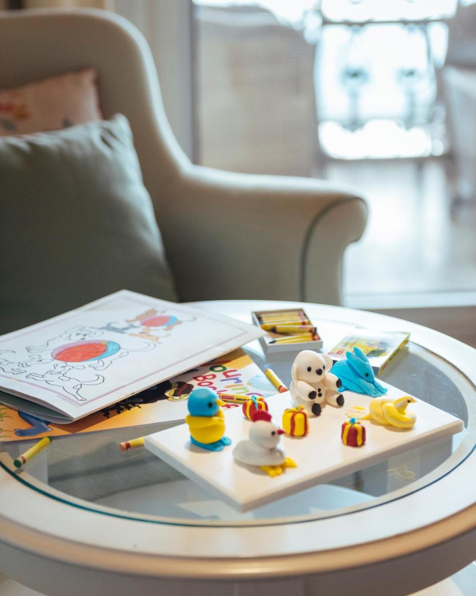 a glass table with toys and a book on it at Welcomhotel by ITC Hotels, The Savoy, Mussoorie in Mussoorie