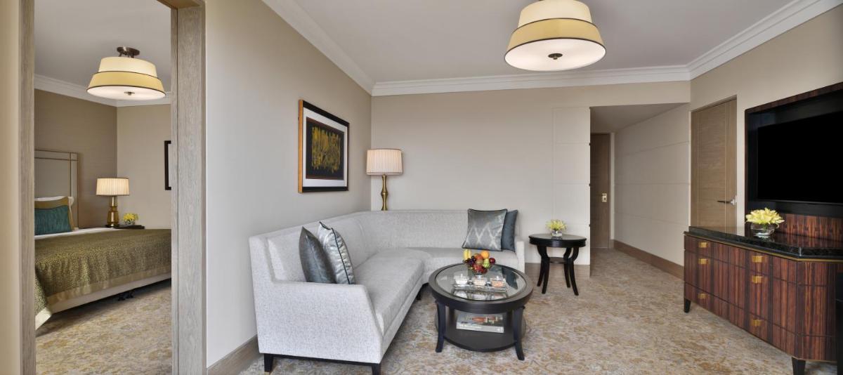 a living room with a couch and a television at Taj Mahal, New Delhi in New Delhi