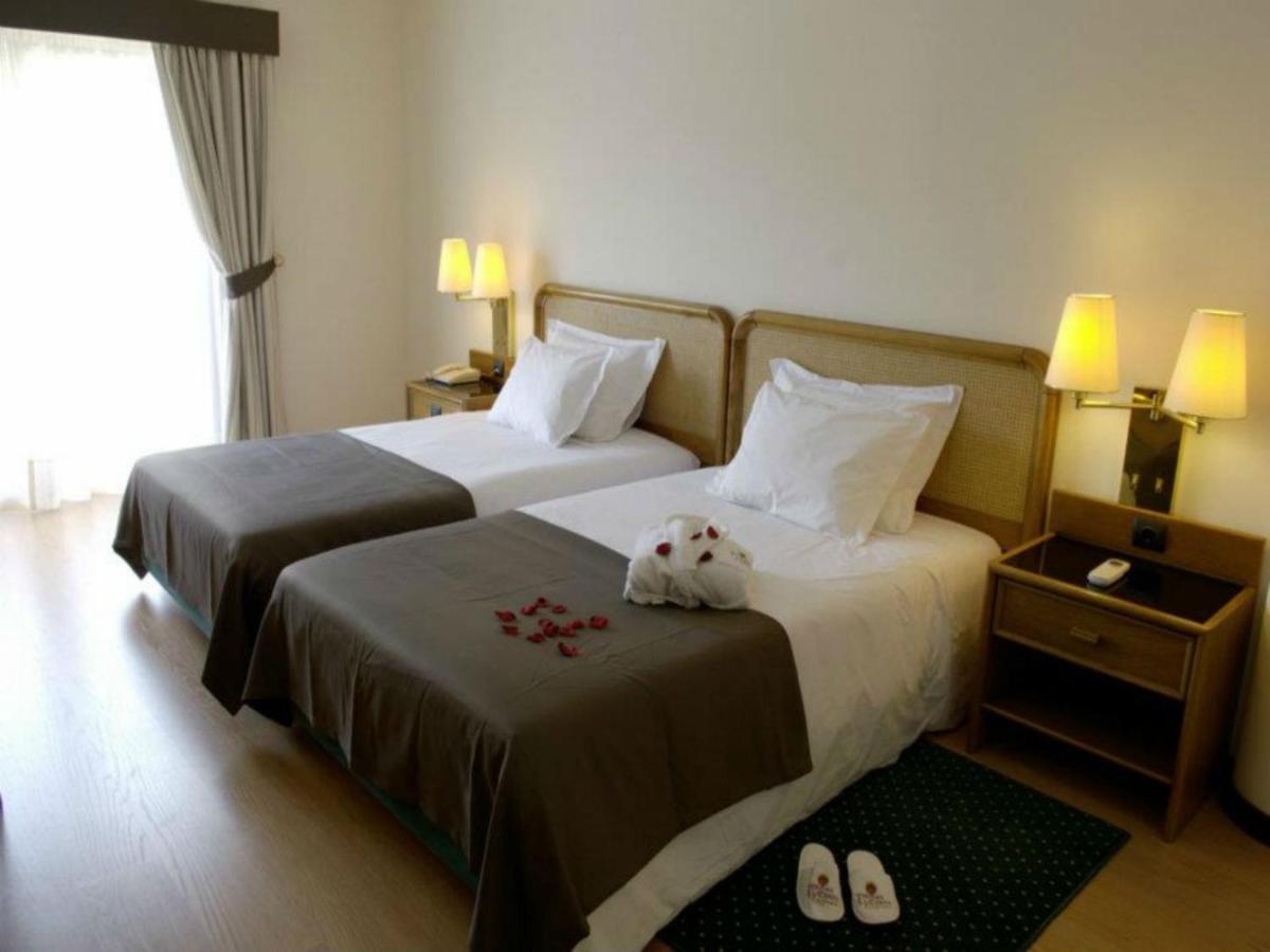 Uma cama ou camas num quarto em Palace Hotel & Spa - Termas de Sao Vicente