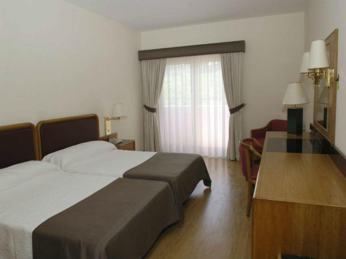 Uma cama ou camas num quarto em Palace Hotel & Spa - Termas de Sao Vicente