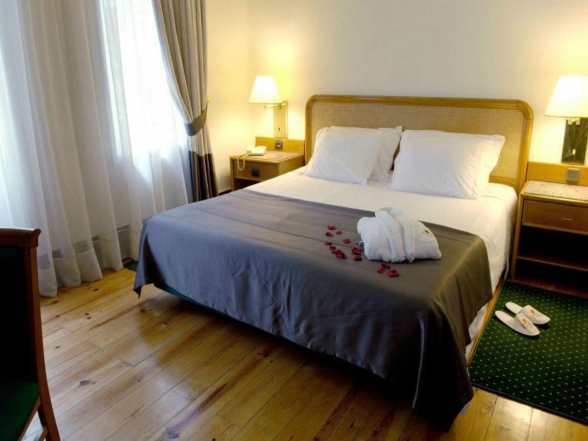 Uma cama ou camas num quarto em Palace Hotel & Spa - Termas de Sao Vicente