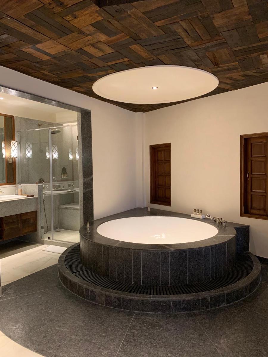a large bathroom with a large tub and a shower at Alila Fort Bishangarh Jaipur - A Hyatt Brand in Jaipur a large bathroom with a large tub and a shower at Alila Fort Bishangarh Jaipur - A Hyatt Brand in Jaipur