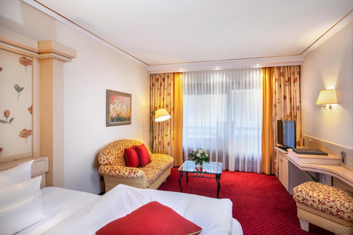 Ein Bett oder Betten in einem Zimmer der Unterkunft Wellness & Genuss Resort - Engel Obertal