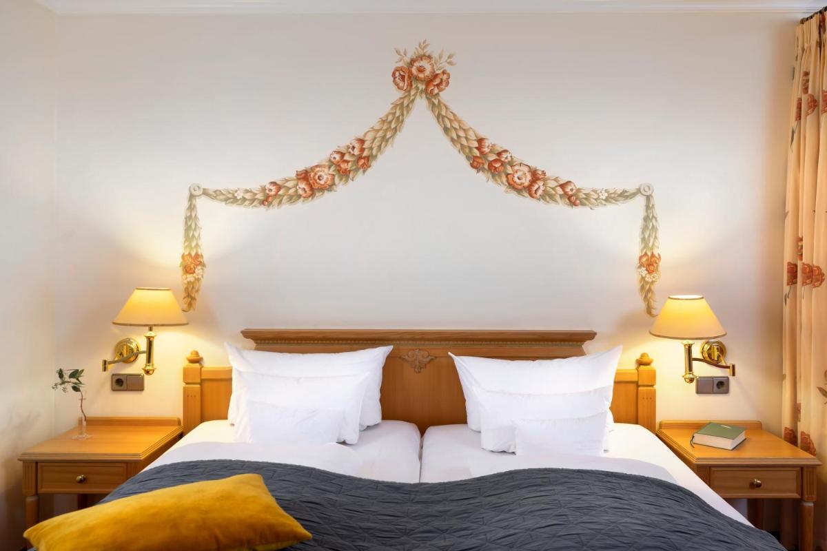 Ein Bett oder Betten in einem Zimmer der Unterkunft Wellness & Genuss Resort - Engel Obertal