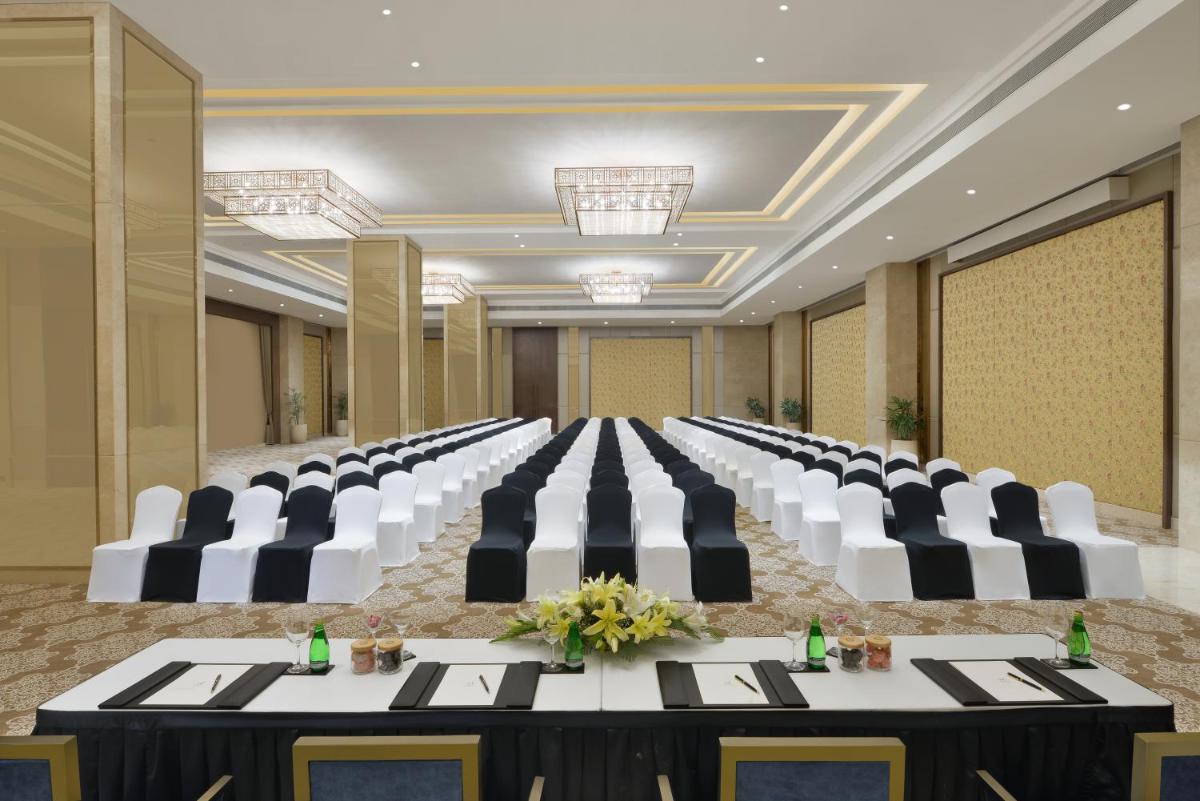 a conference room with a long table and chairs at Taj Skyline Ahmedabad in Ahmedabad +30 photos