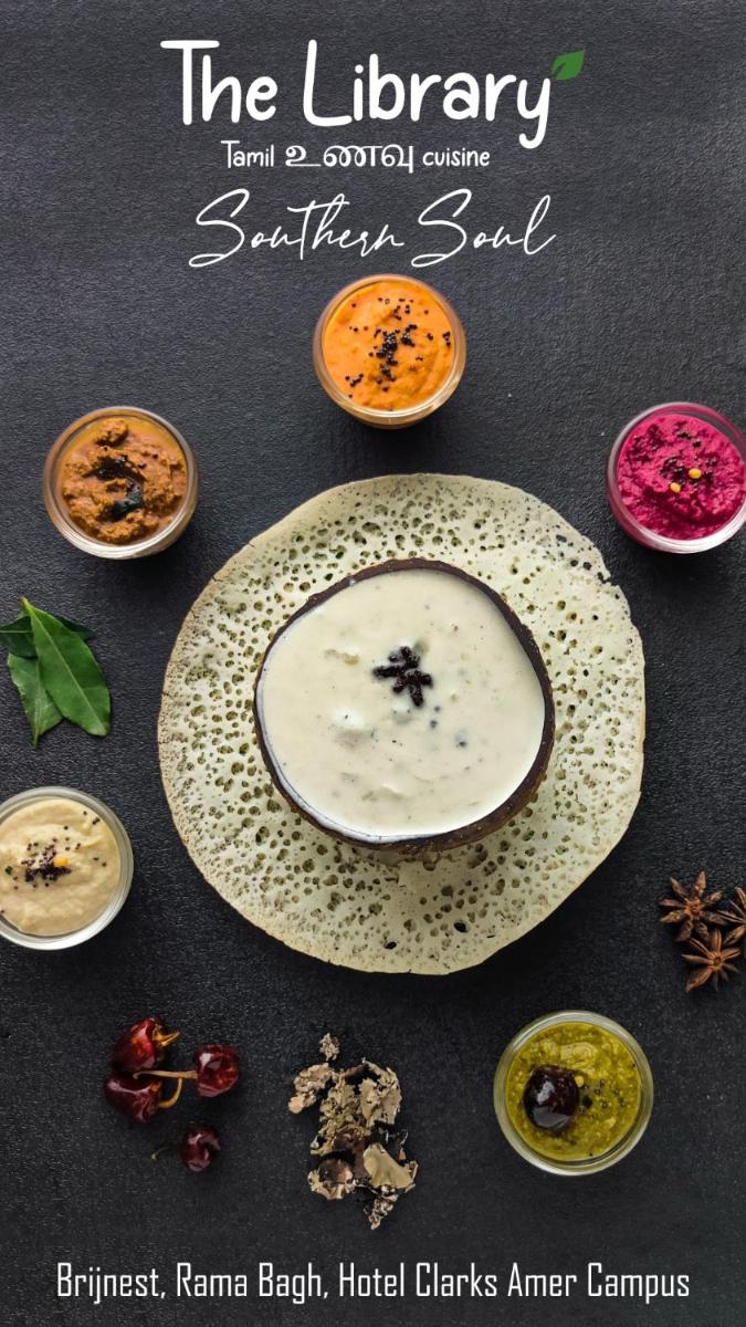 a plate on a table with different types of food at Brij Nest, Jaipur - An All Suite Boutique Hotel in Jaipur