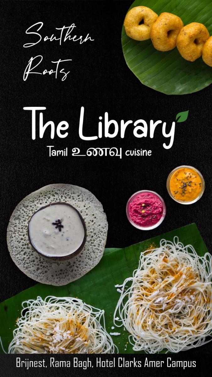 a book about the library with food on a banana leaf at Brij Nest, Jaipur - An All Suite Boutique Hotel in Jaipur