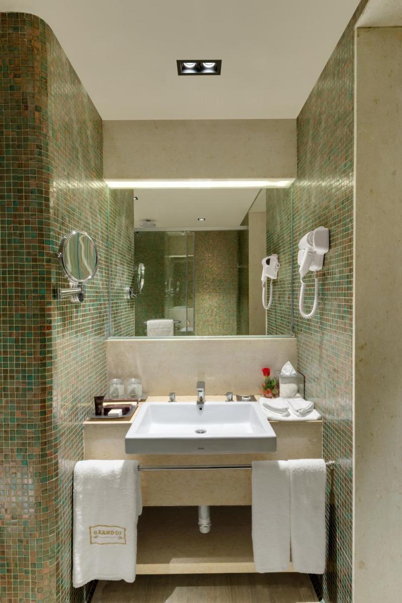 a bathroom with a sink and a mirror at Wyndham Ahmedabad Shela in Ahmedabad