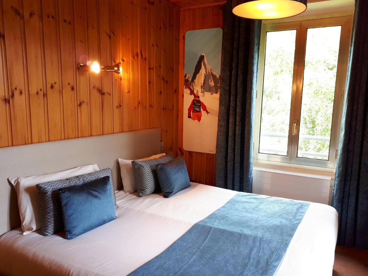 Un ou plusieurs lits dans un hébergement de l'établissement Aiguille du Midi - Hôtel & Restaurant