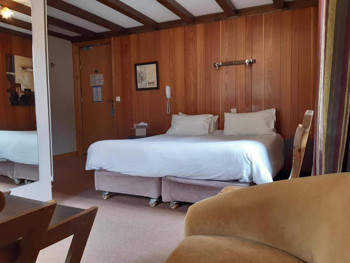 Un ou plusieurs lits dans un hébergement de l'établissement Aiguille du Midi - Hôtel & Restaurant