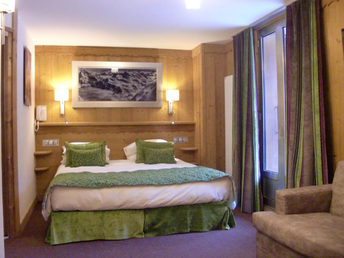 Un ou plusieurs lits dans un hébergement de l'établissement Aiguille du Midi - Hôtel & Restaurant