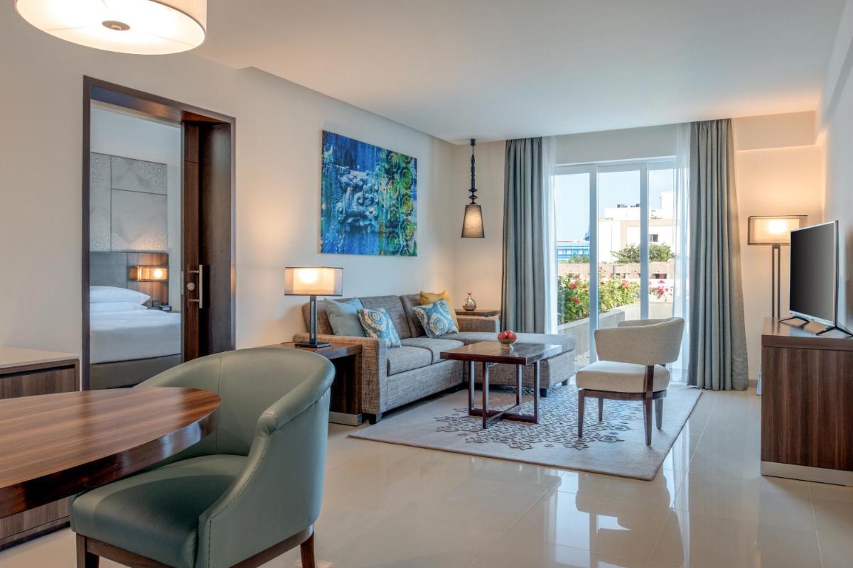 a living room with a couch and a table at The Residency Towers, Rameswaram in Rāmeswaram