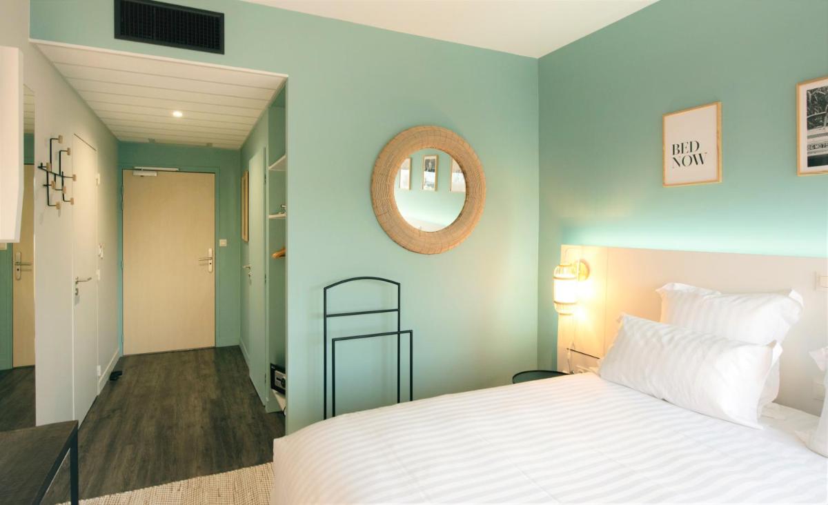 Un ou plusieurs lits dans un hébergement de l'établissement PADJA Hôtel & Spa Vannes