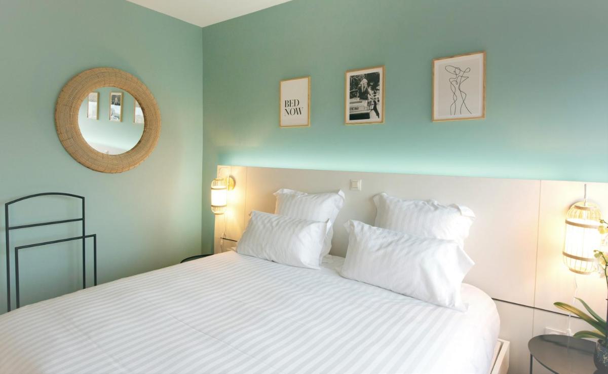 Un ou plusieurs lits dans un hébergement de l'établissement PADJA Hôtel & Spa Vannes