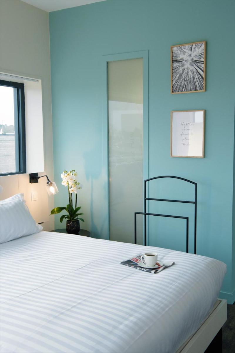Un ou plusieurs lits dans un hébergement de l'établissement PADJA Hôtel & Spa Vannes