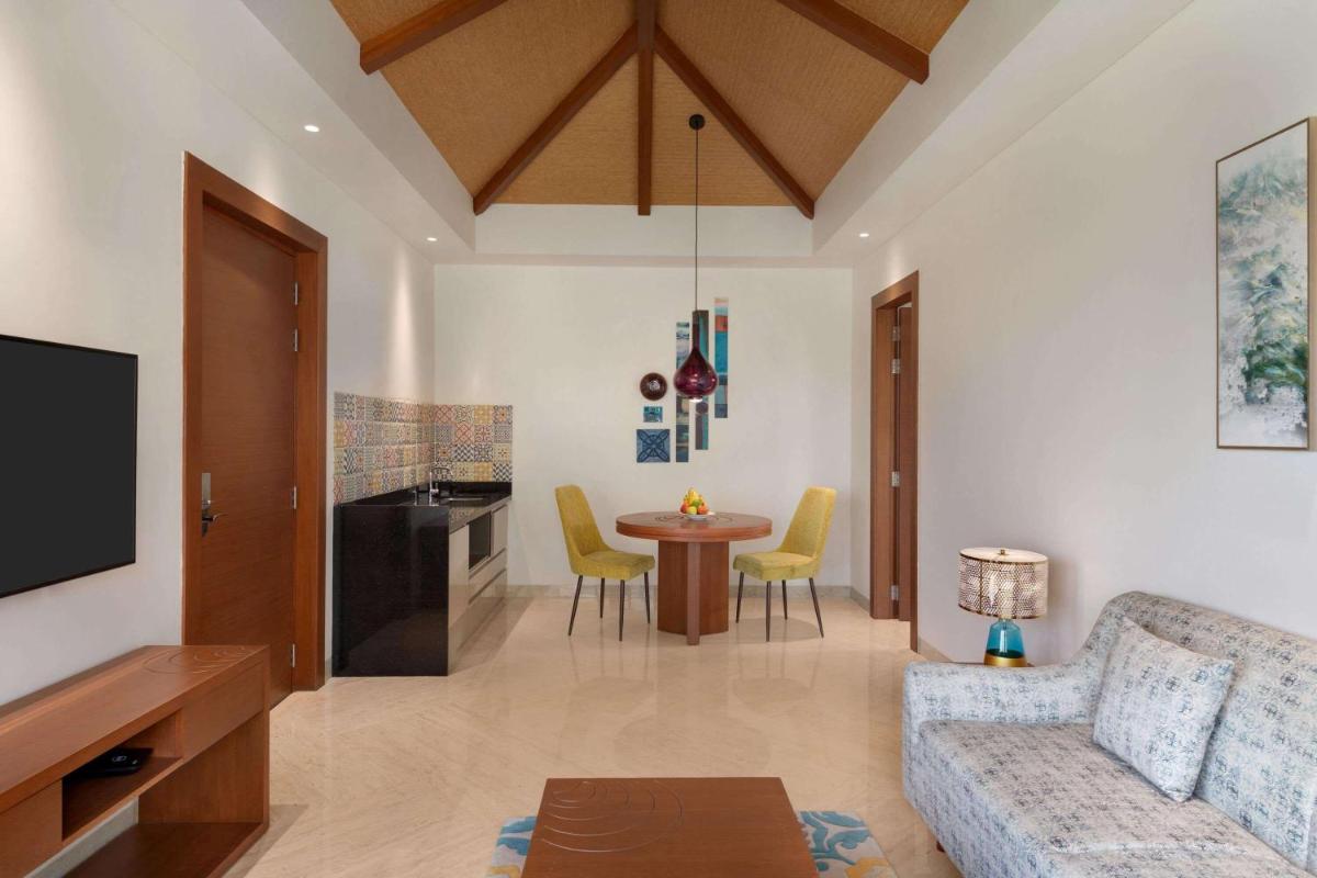 a living room with a couch and a table at Hawthorn Suites by Wyndham Dwarka in Dwarka a living room with a couch and a table at Hawthorn Suites by Wyndham Dwarka in Dwarka