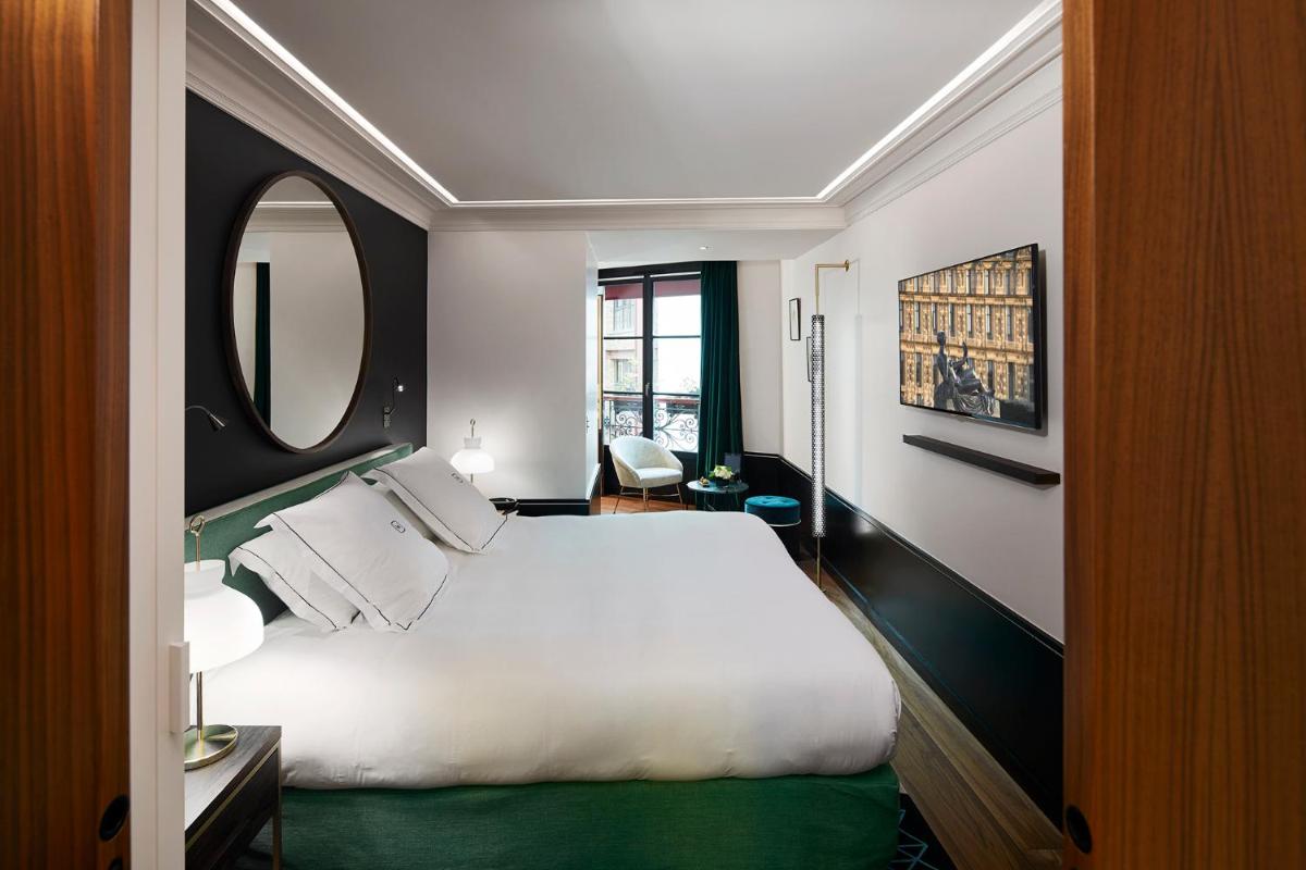 Un ou plusieurs lits dans un hébergement de l'établissement Le Roch Hotel & Spa