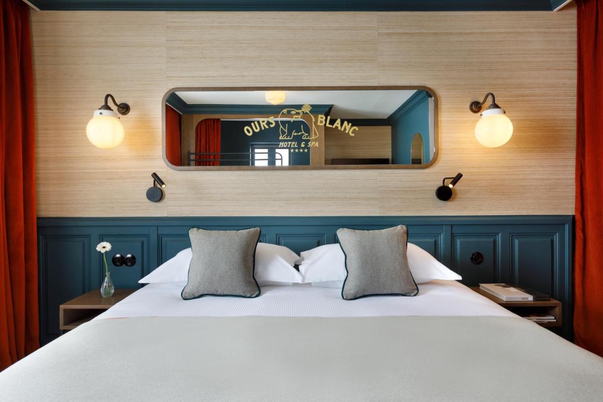 Un ou plusieurs lits dans un hébergement de l'établissement Ours Blanc Hotel & Spa