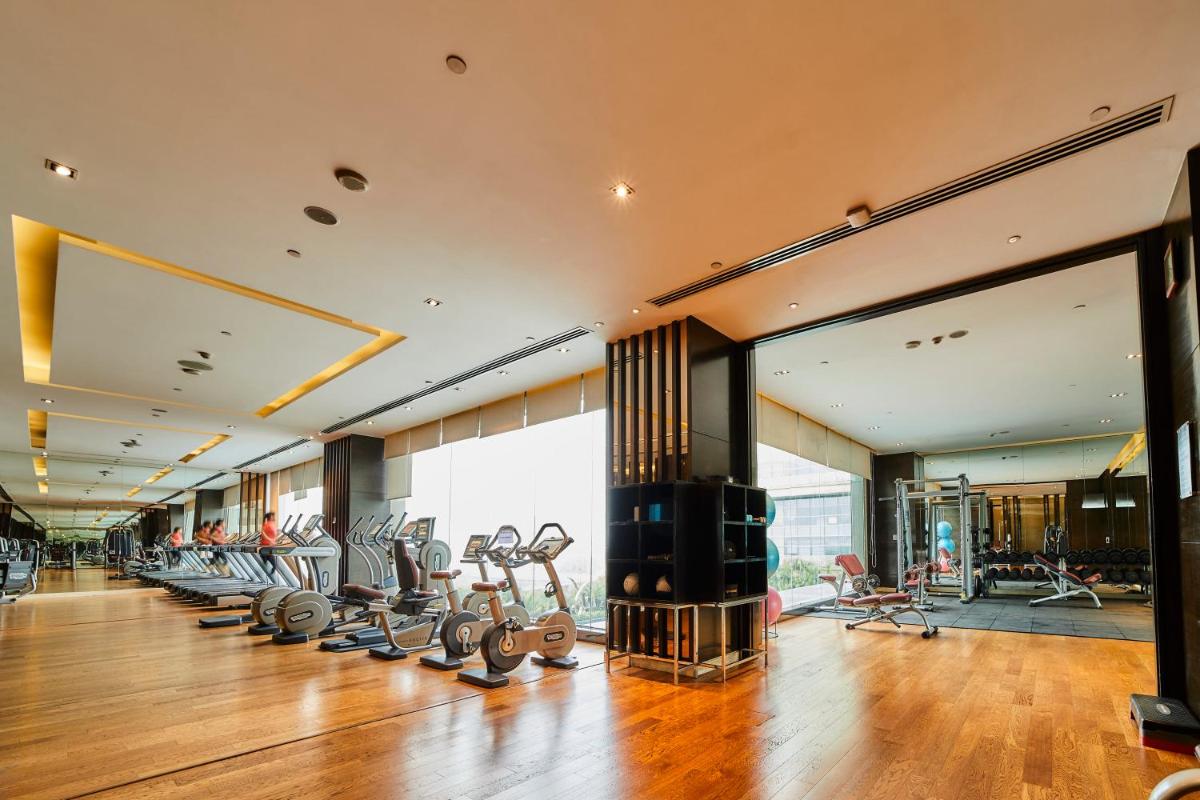 a gym with treadmills and elliptical machines at Crowne Plaza New Delhi Rohini by IHG in New Delhi a gym with treadmills and elliptical machines at Crowne Plaza New Delhi Rohini by IHG in New Delhi