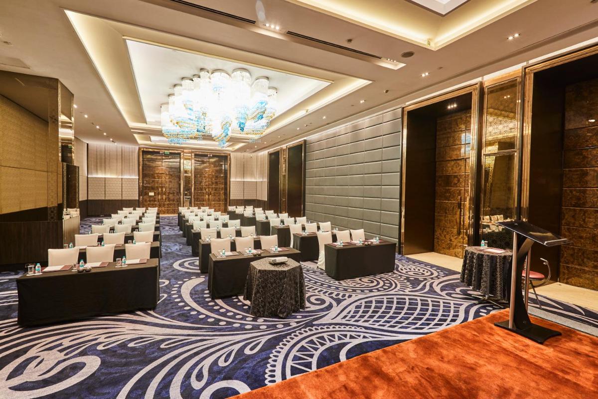 a conference room with rows of chairs and a chandelier at Crowne Plaza New Delhi Rohini by IHG in New Delhi a conference room with rows of chairs and a chandelier at Crowne Plaza New Delhi Rohini by IHG in New Delhi