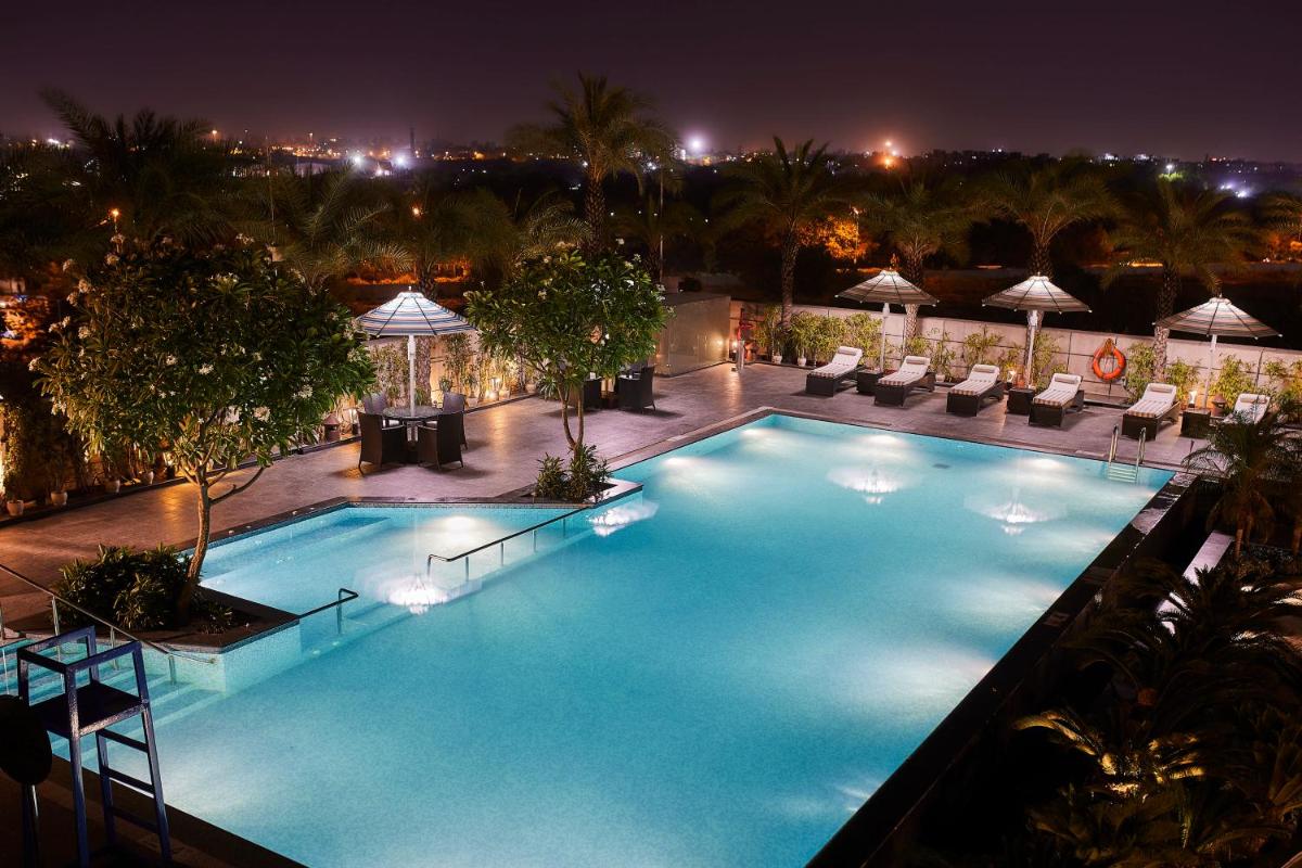 a large swimming pool on top of a hotel at night at Crowne Plaza New Delhi Rohini by IHG in New Delhi a large swimming pool on top of a hotel at night at Crowne Plaza New Delhi Rohini by IHG in New Delhi