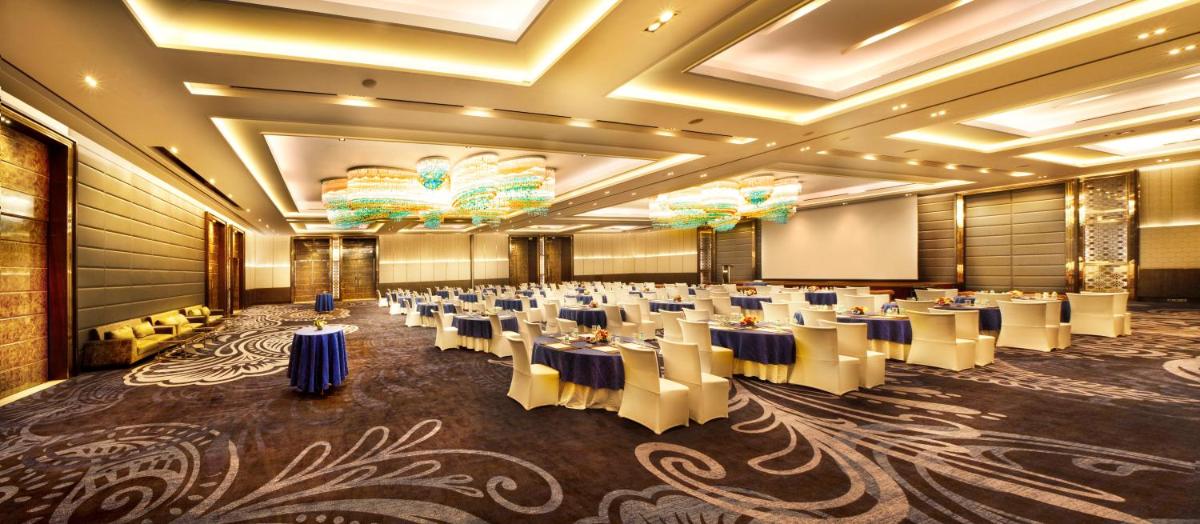 a banquet hall with tables and chairs in a room at Crowne Plaza New Delhi Rohini by IHG in New Delhi a banquet hall with tables and chairs in a room at Crowne Plaza New Delhi Rohini by IHG in New Delhi