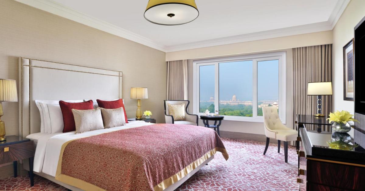 a hotel room with a bed and a large window at Taj Mahal, New Delhi in New Delhi