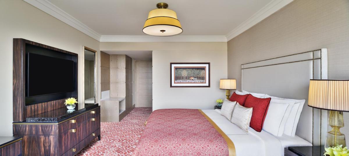 a hotel room with a bed and a flat screen tv at Taj Mahal, New Delhi in New Delhi
