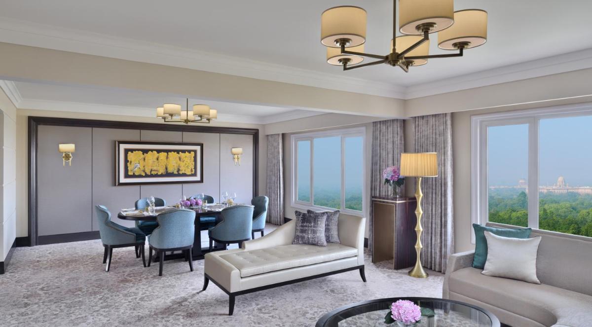 a living room with a table and a dining room at Taj Mahal, New Delhi in New Delhi