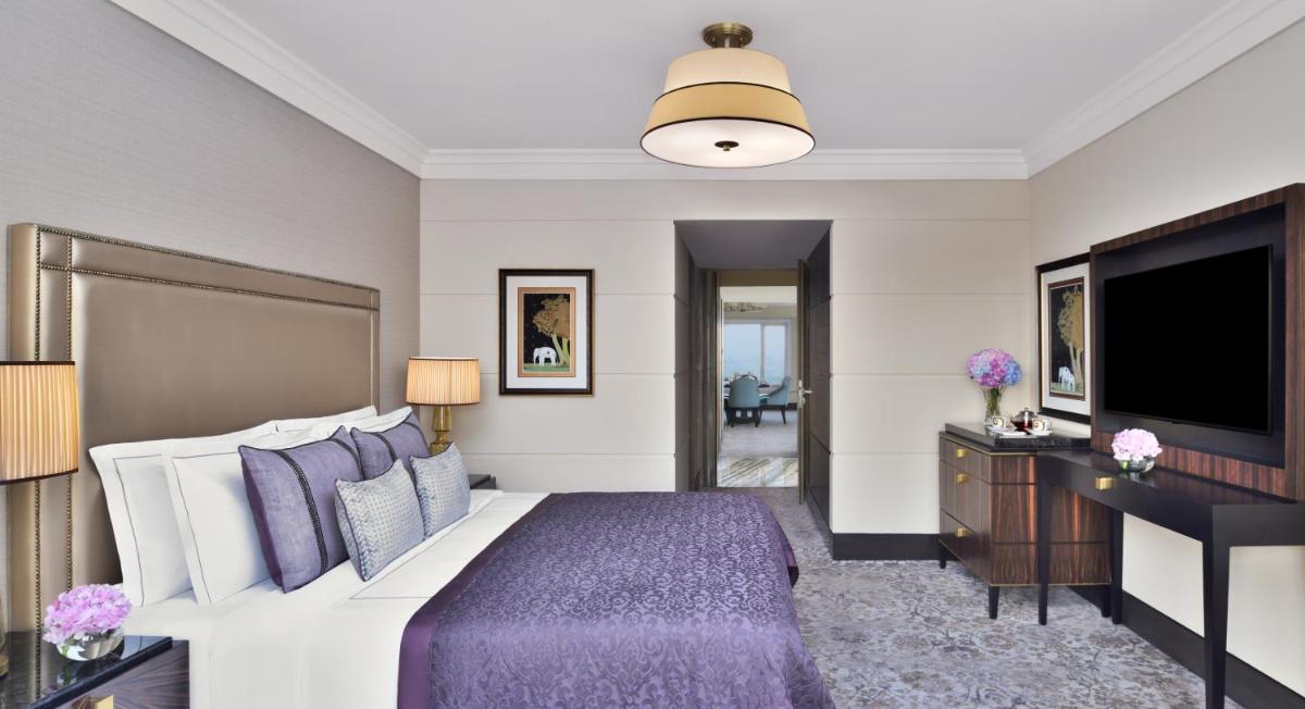 a bedroom with a bed and a flat screen tv at Taj Mahal, New Delhi in New Delhi