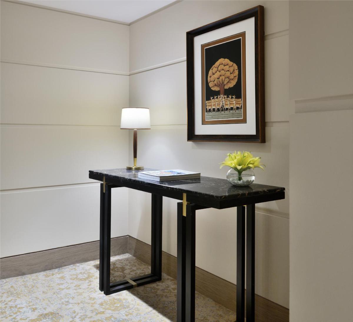 a black table with a lamp on it in a room at Taj Mahal, New Delhi in New Delhi