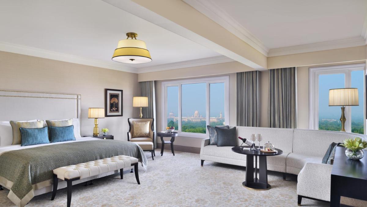 a bedroom with a bed and a living room with a couch at Taj Mahal, New Delhi in New Delhi