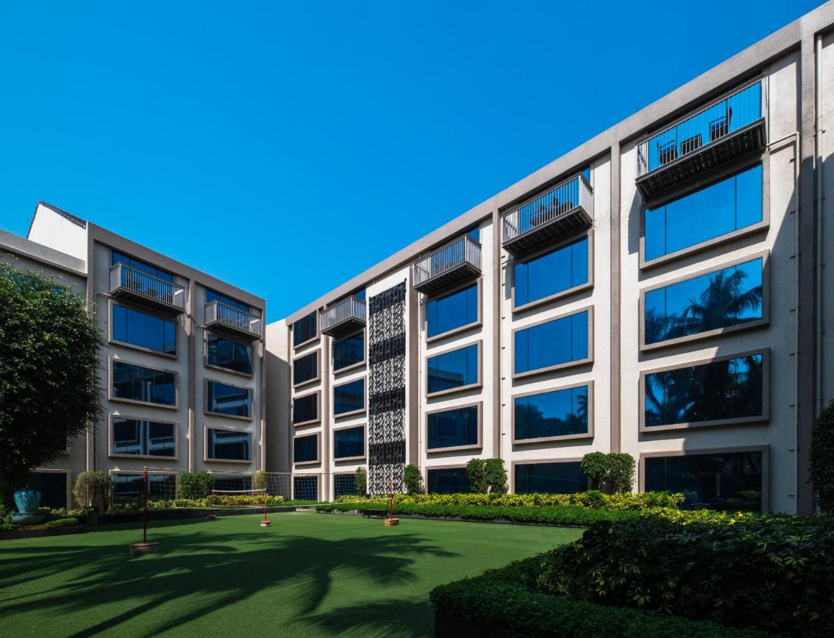 an office building with a lawn in front of it at Hyatt Centric Candolim Goa in Calangute an office building with a lawn in front of it at Hyatt Centric Candolim Goa in Calangute